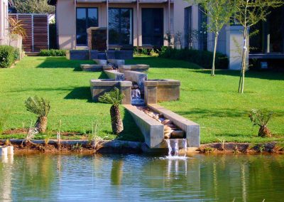 Modern water feature with clean lines and pebble base installed in a Durban garden by Creative Landscapes