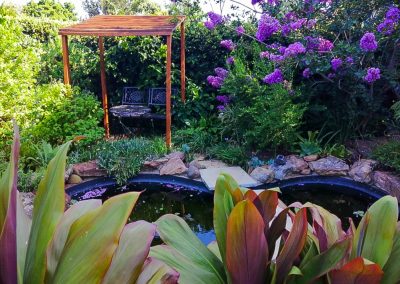 Secluded garden retreat with lush planting and stone pathways, landscaped by Creative Landscapes in Durban