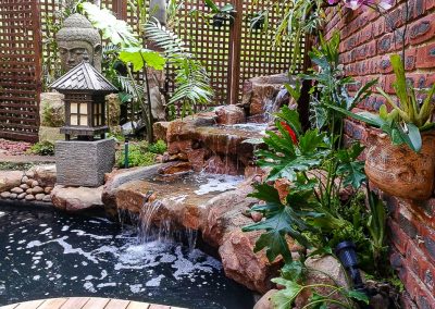 Soothing backyard water feature surrounded by greenery in Durban, designed by Creative Landscapes